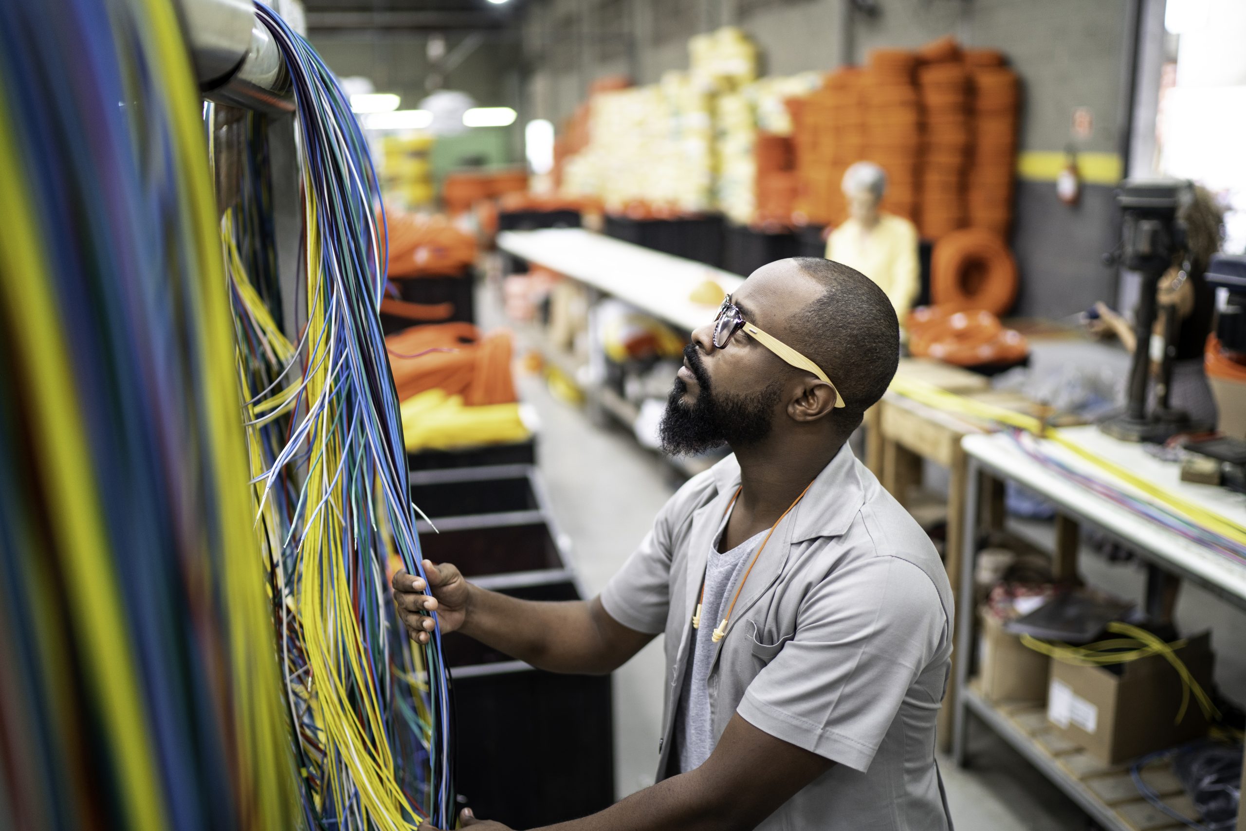 Network engineer organizing and routing structured cabling.
